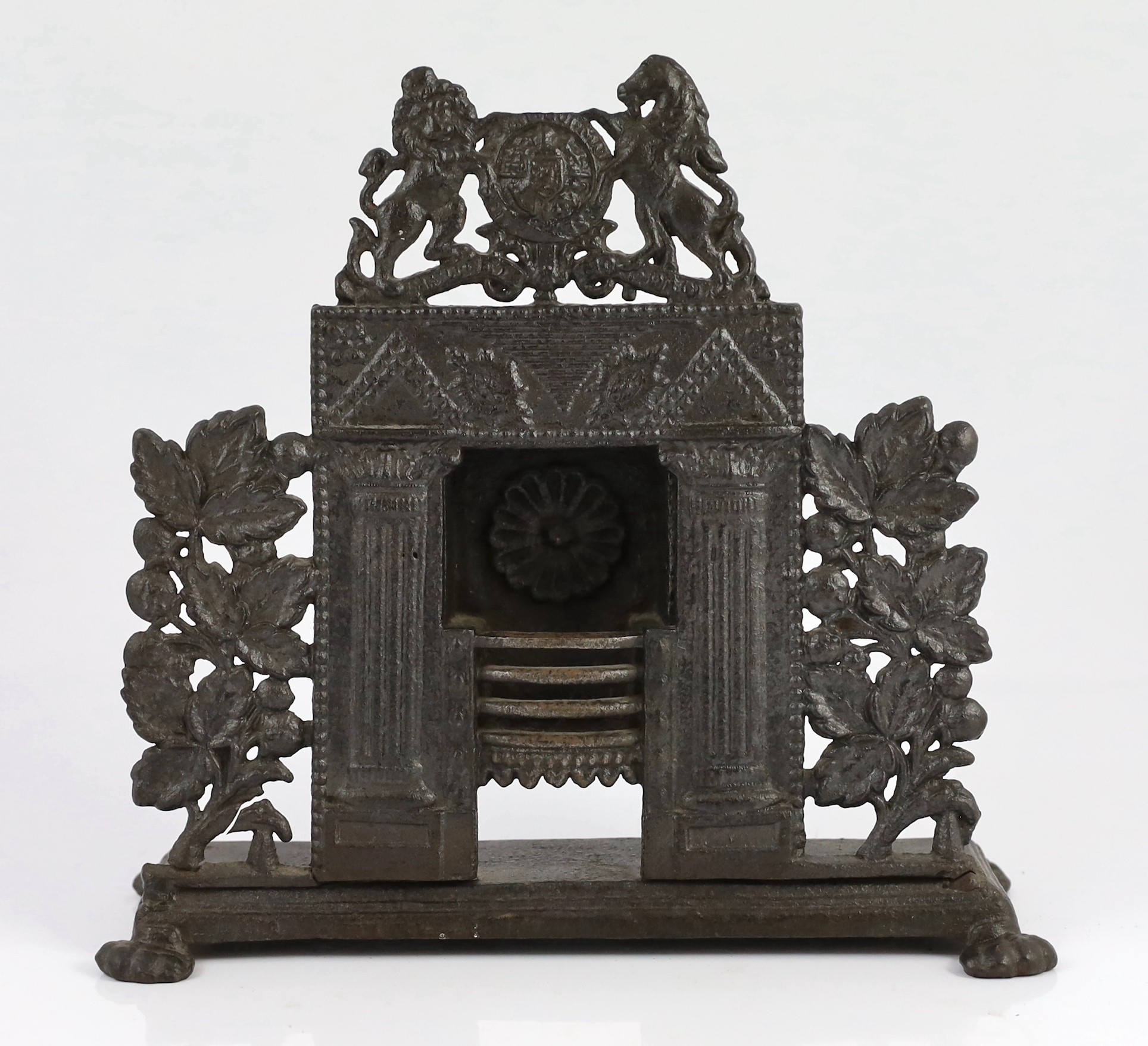 Three early 19th century cast iron model fire grates, two incorporating Royal Arms, largest 12in. wide